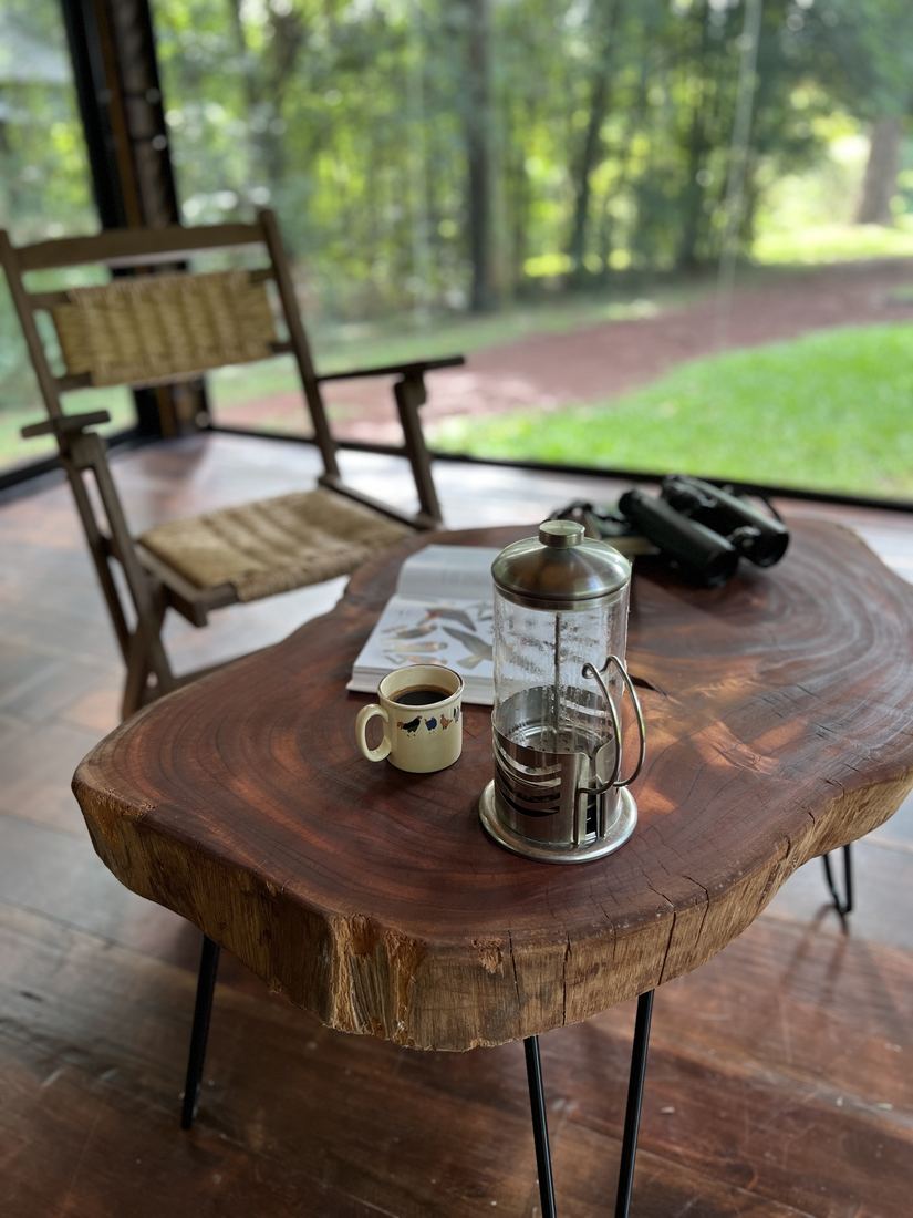 Café y binoculares en la mesa de la galería